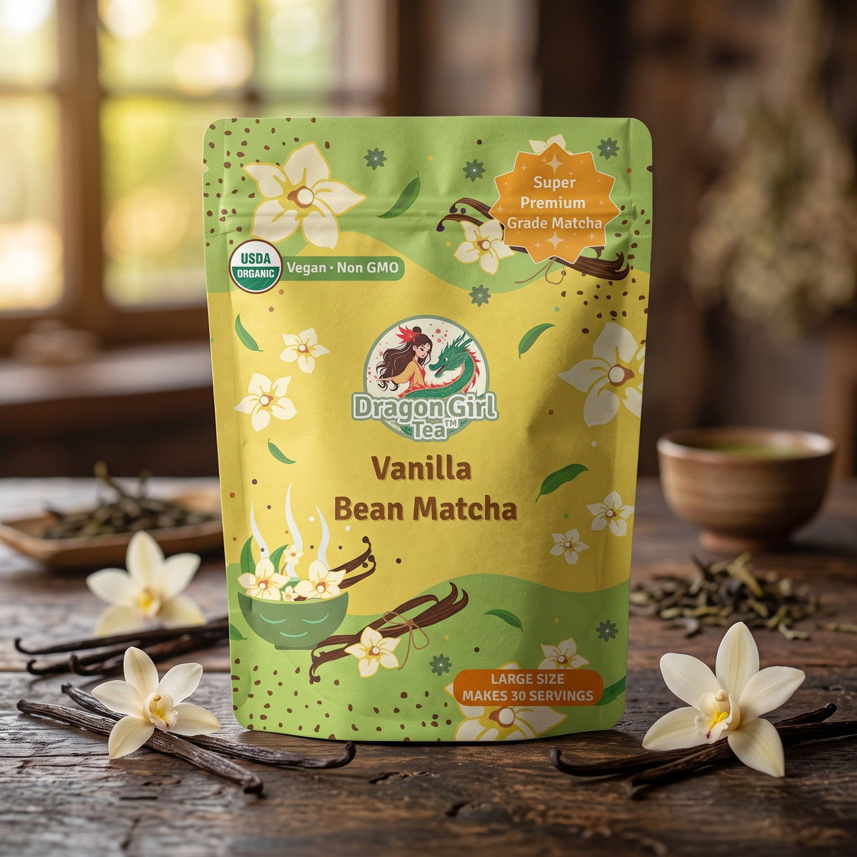 A stand-up pouch of Dragon Girl Tea Vanilla Bean Matcha tea is displayed on a rustic wooden table with vanilla beans and flowers. The packaging is lime green and yellow with illustrations of flowers, vanilla pods, and a bowl of tea.